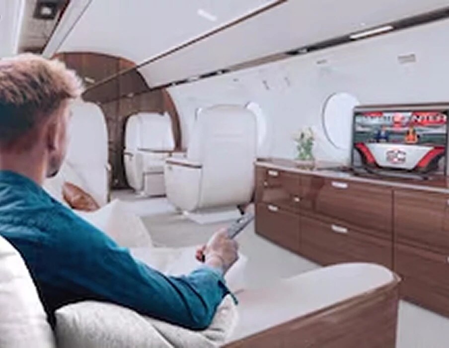 Customer relaxing with a remote, watching DIRECTV
