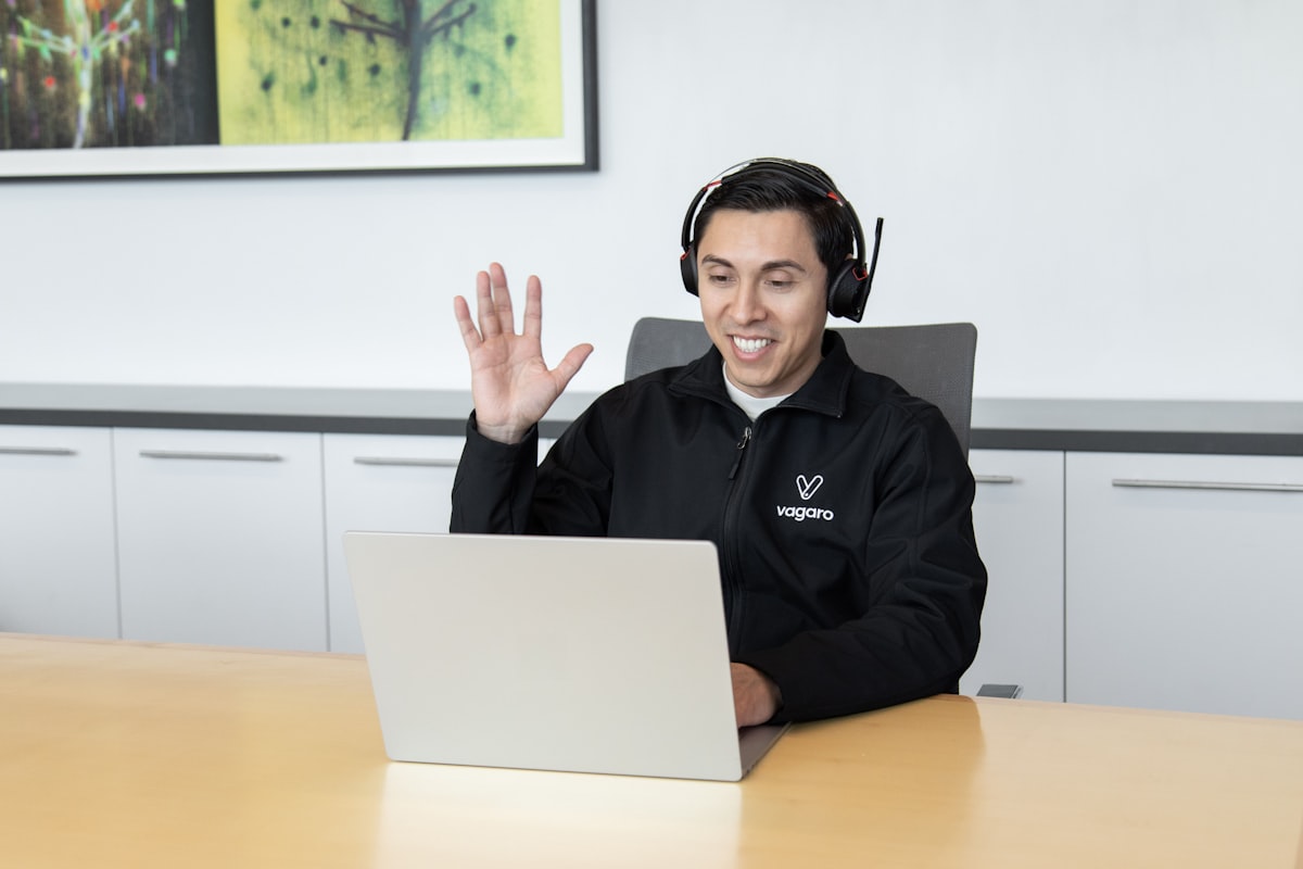 An OCA agent on a headset at their desk