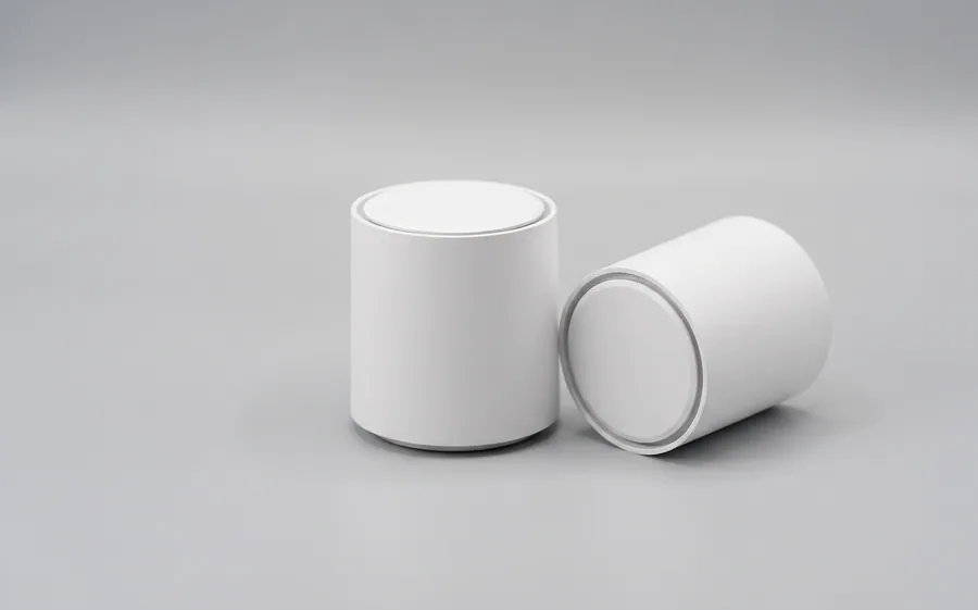 Two small white mesh Wi-Fi extender nodes